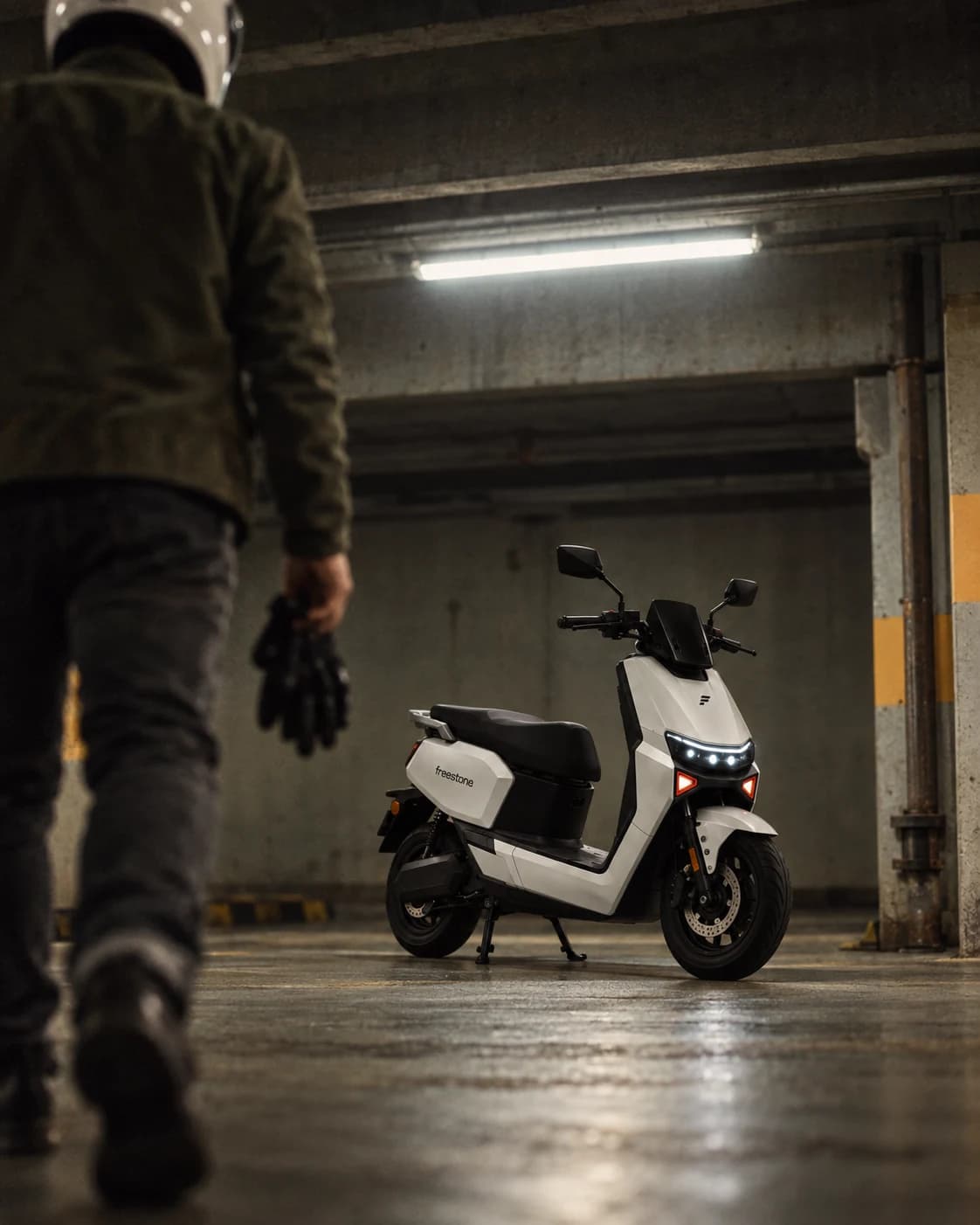 Pearl White Freestone 02 with its lights on in a parking structure